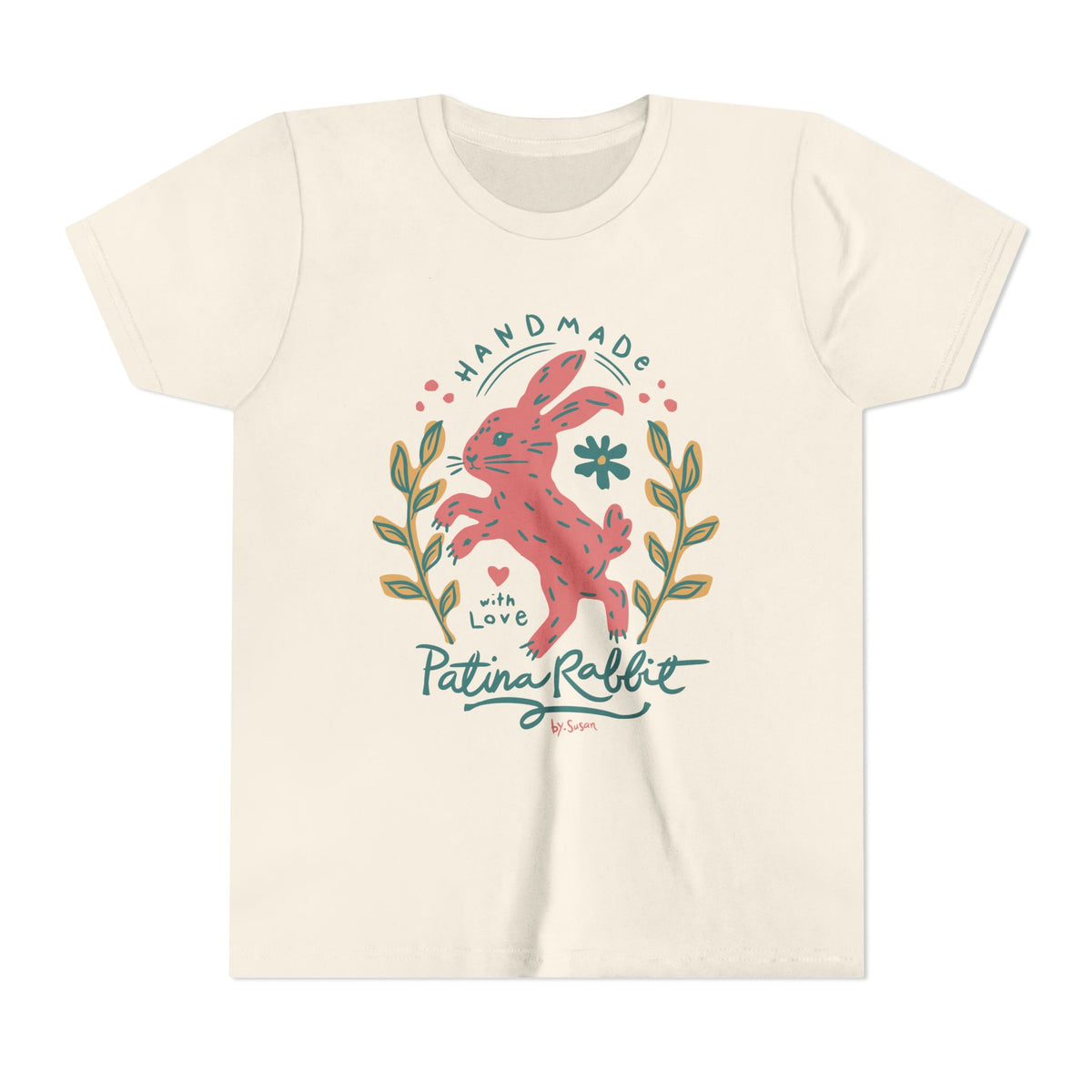 An off-white short-sleeve t-shirt with a colorful graphic of a jumping pink rabbit surrounded by green leaves and the text 'HANDMADE with Love Patina Rabbit'.