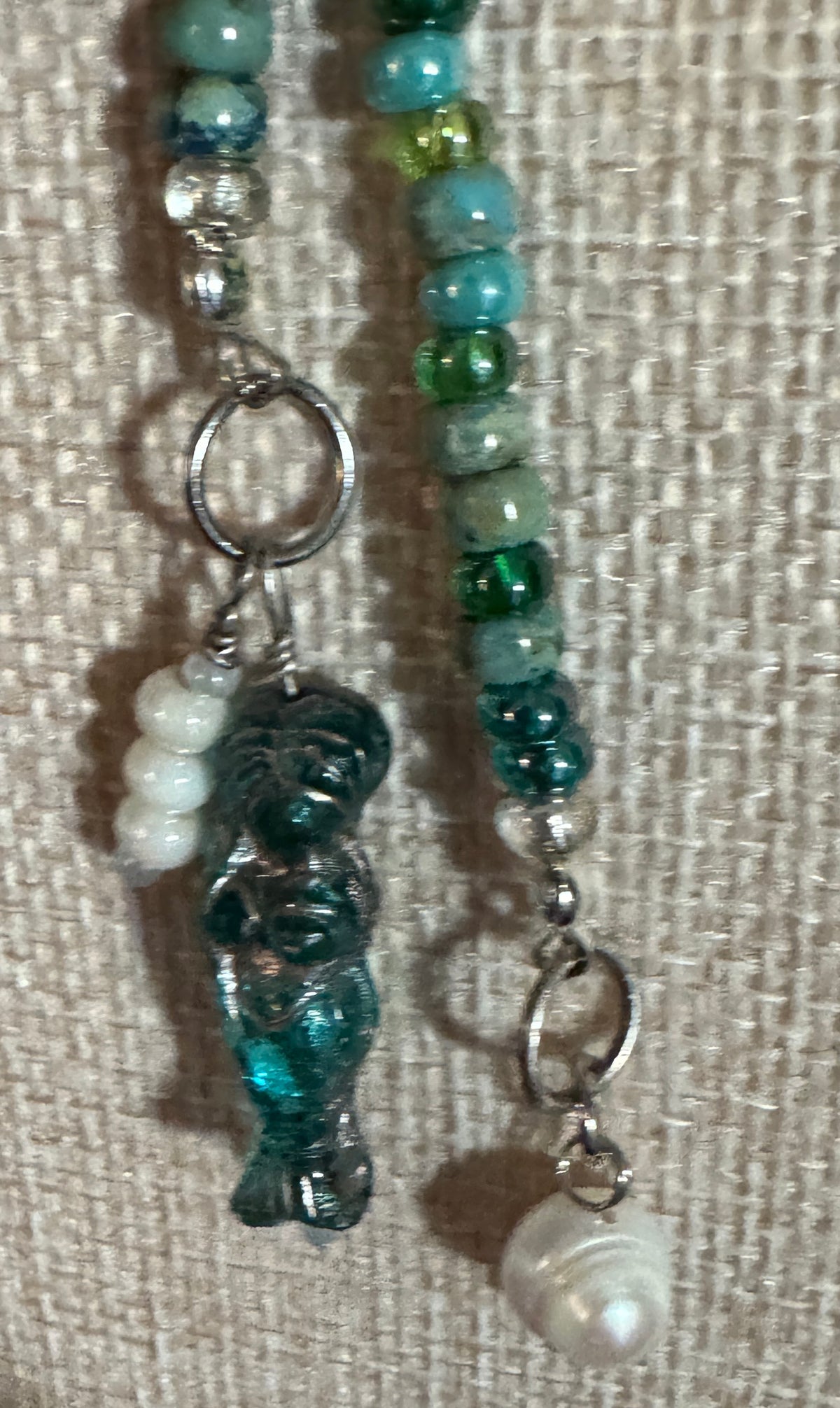 Blue Lagoon 48-inch handmade lariat necklace with turquoise, blue and green beads, silver accents and pearl drop.