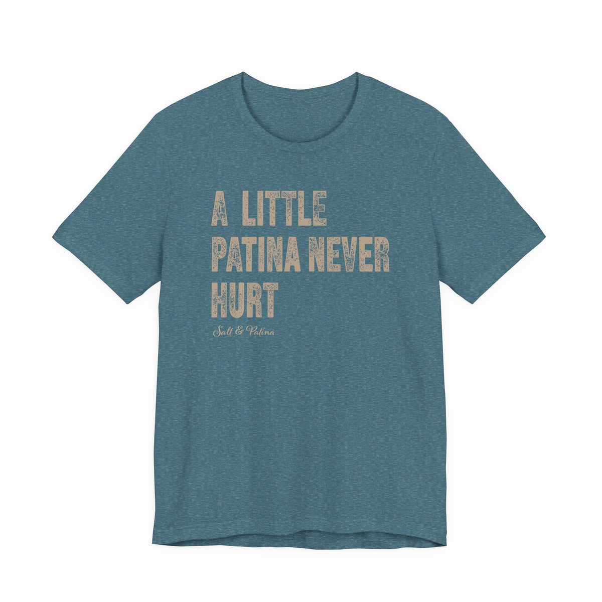 A heathered teal blue short-sleeve t-shirt with the phrase 'A LITTLE PATINA NEVER HURT' printed in distressed beige block letters on the front, with a small 'Salt & Patina' logo underneath, shown against a plain white background.