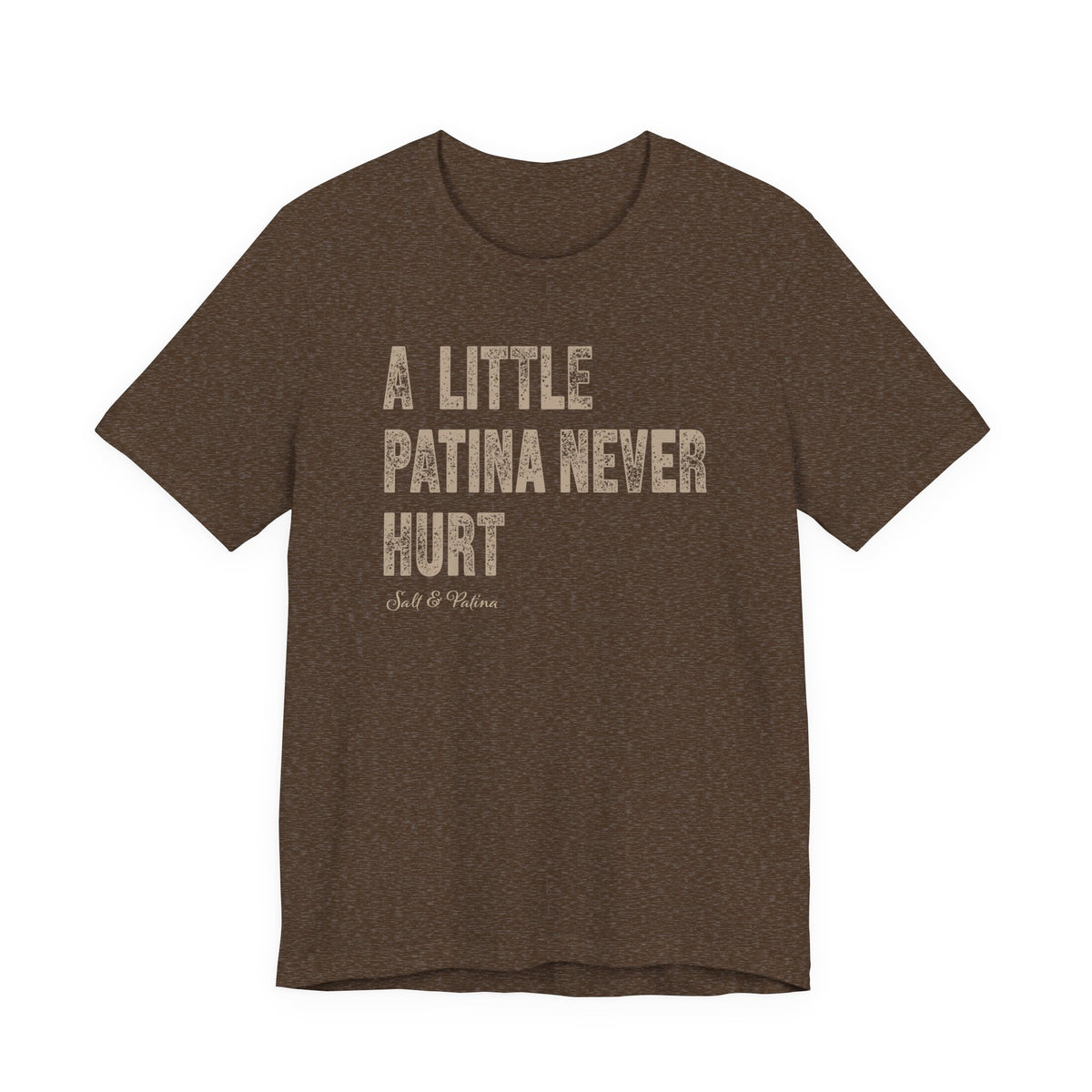 A heathered brown short-sleeve t-shirt with the phrase 'A LITTLE PATINA NEVER HURT' printed in distressed beige block letters on the front, with a small 'Salt & Patina' logo underneath, shown against a plain white background.