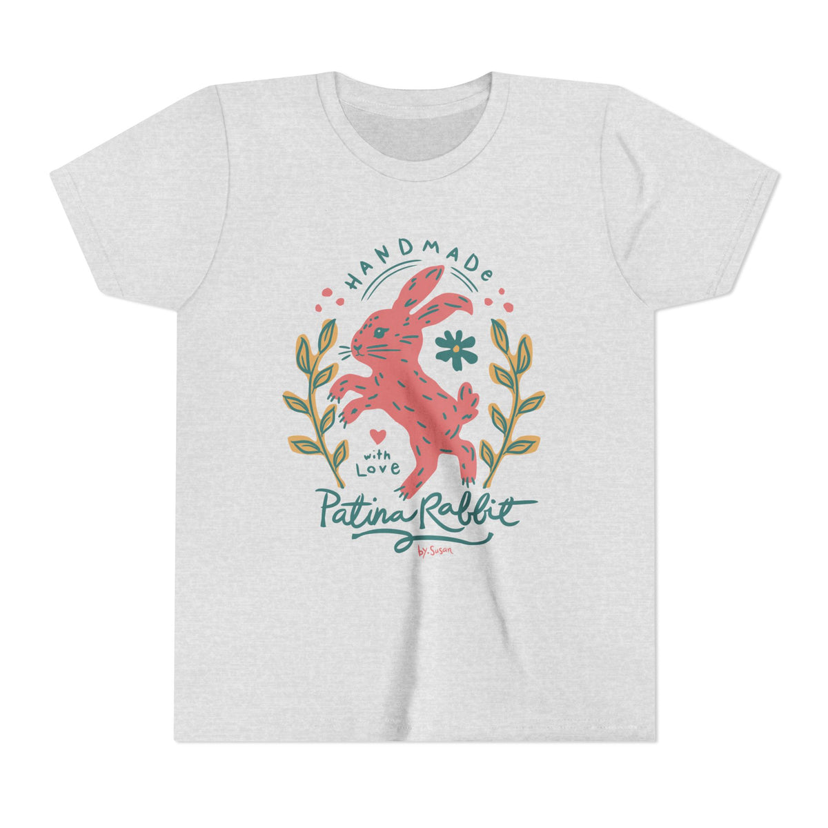 A light heather gray short-sleeve t-shirt with a colorful graphic on the front featuring a pink rabbit, green leaves, and teal text that reads 'HANDMADE with Love Patina Rabbit'.