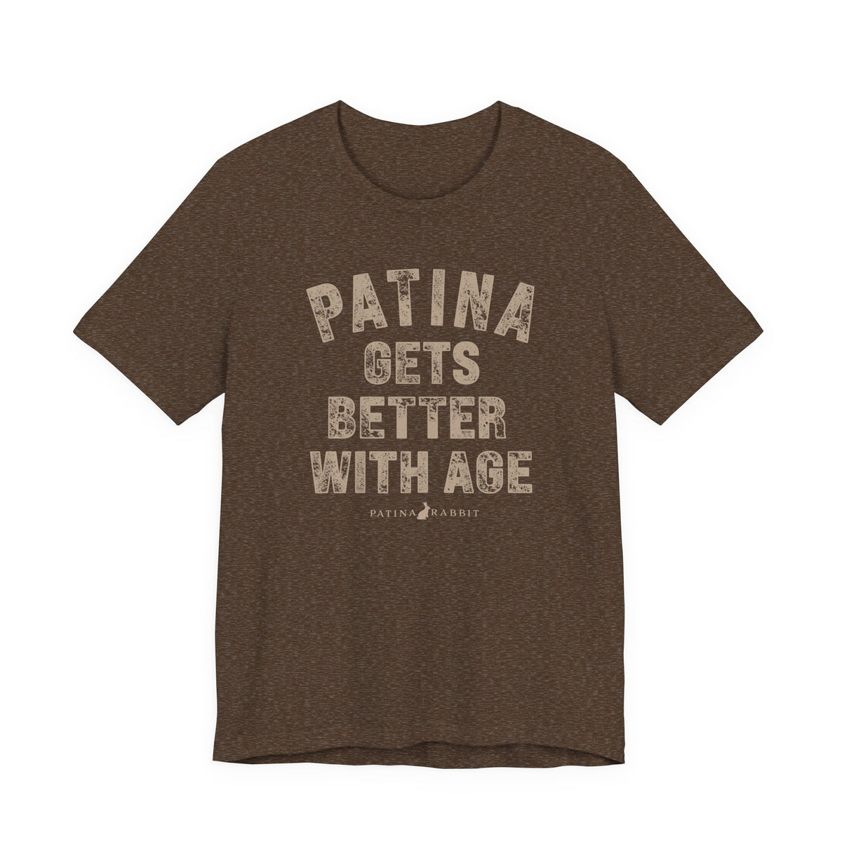 A heathered brown crewneck t-shirt with a distressed beige graphic text that reads 'PATINA GETS BETTER WITH AGE' and a small 'PATINA RABBIT' logo underneath, 