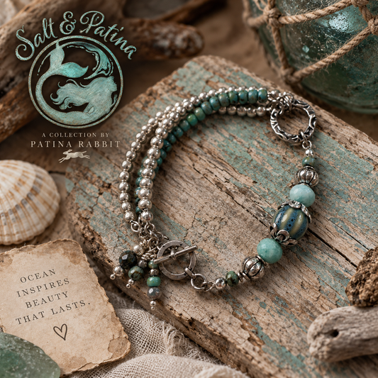 A bohemian-style beaded bracelet with silver-toned beads, turquoise-green beads, and a blue marbled accent bead, styled on a rustic weathered wood plank with a shell, rope, and a 'Salt & Patina' brand logo overlay.