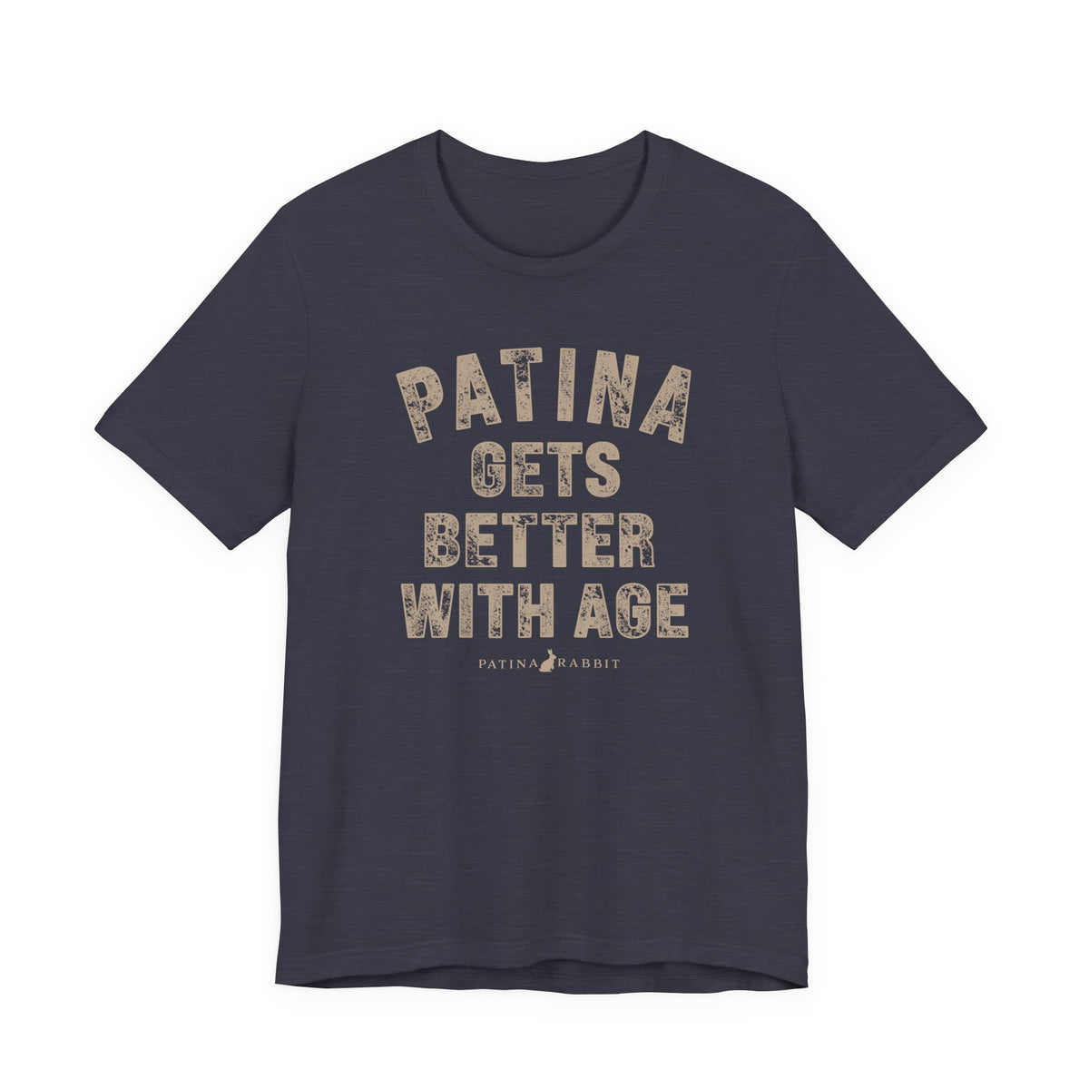A heathered navy crewneck t-shirt with a distressed beige graphic text that reads 'PATINA GETS BETTER WITH AGE' and a small 'PATINA RABBIT' logo underneath, 