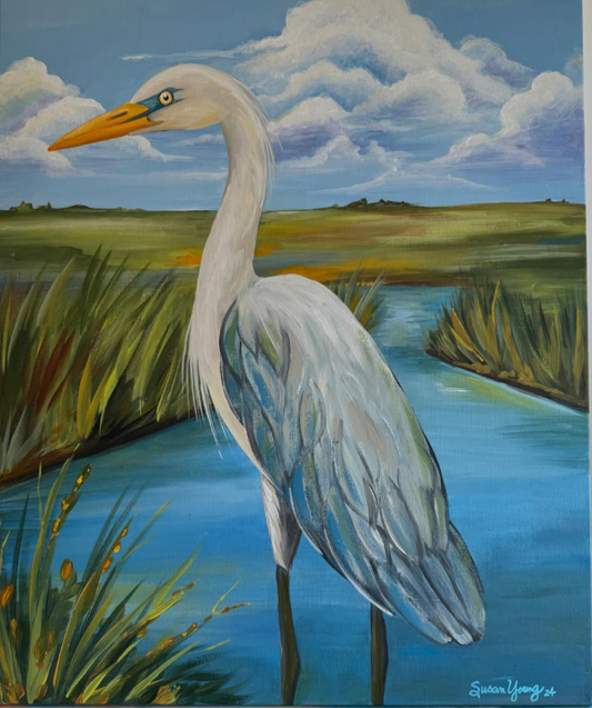 A painted marsh scene featuring a large white heron with a yellow beak standing in blue water, with reeds, grasses, distant land, and a cloudy sky in the background.