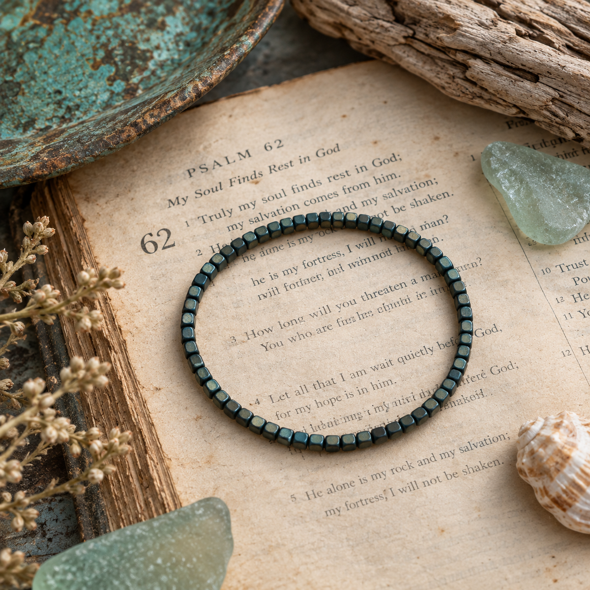 Little Layers Matte Teal bracelet displayed on a vintage Bible page with aqua sea glass, driftwood and dried flowers.