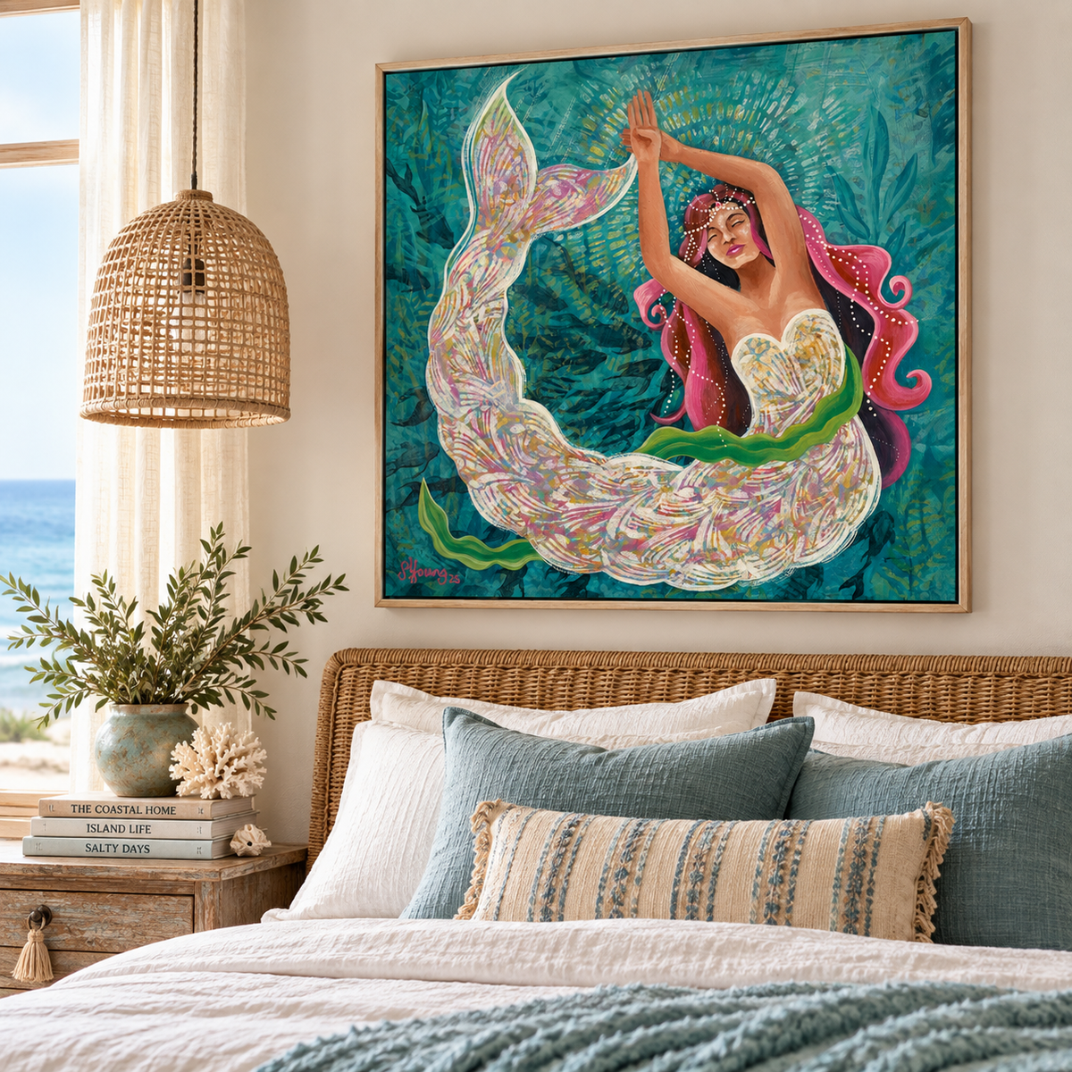A framed art print of a mermaid in a colorful, swirling tail hanging on a beige wall above a bed with blue and beige pillows in a styled bedroom setting.